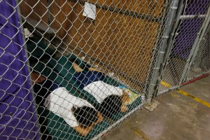 NOGALES, AZ - JUNE 18:  Two female detainees sleep in a holding cell, as the children are separated by age group and gender, as hundreds of mostly Central American immigrant children are being processed and held at the U.S. Customs and Border Protection Nogales Placement Center on June 18, 2014, in Nogales, Arizona.  Brownsville, Texas, and Nogales, have been central to processing the more than 47,000 unaccompanied children who have entered the country illegally since Oct. 1. (Photo by Ross D. Franklin-Pool/Getty Images)