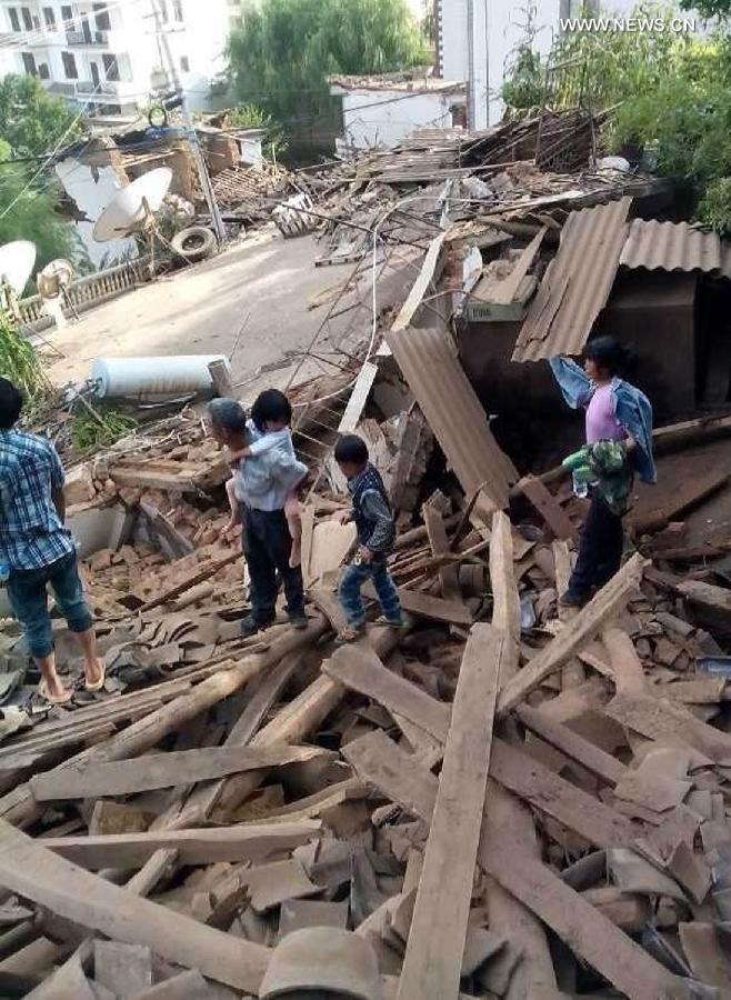 Survivors survey the rubble. Picture courtesy of Xinhua News. 